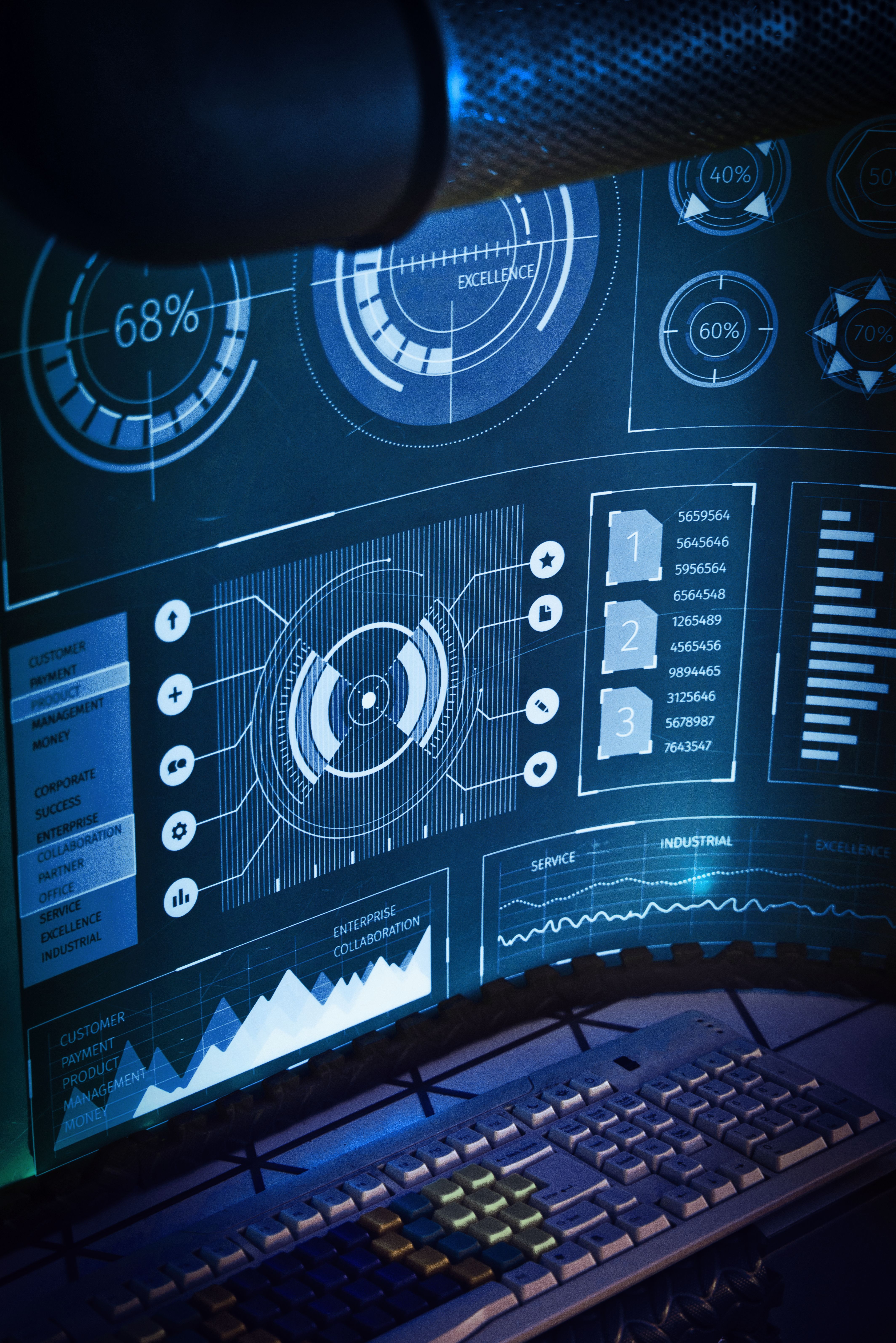 Vertical shot of wide computer screen with futuristic diagrams